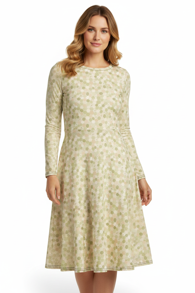 Woman wearing a long-sleeve, knee-length dress with a floral pattern on a white background