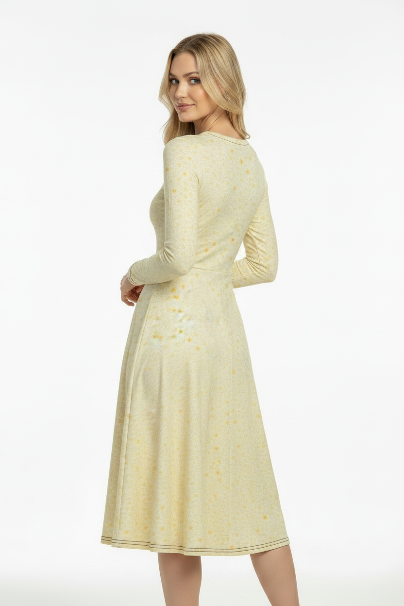 Beautiful woman wearing a long sleeve midi dress in a yellow floral design 